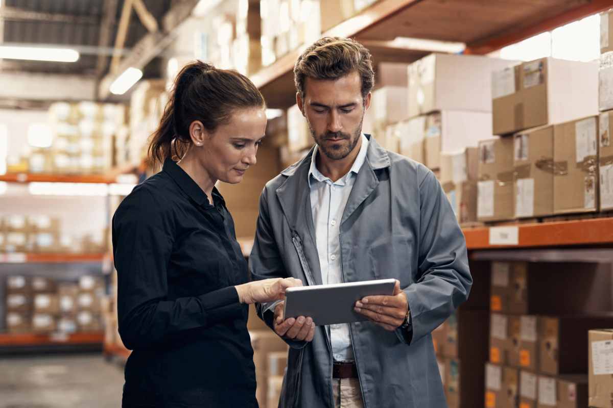 two business owners using inventory management software in a warehouse