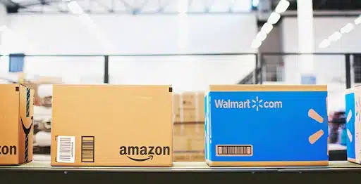 Amazon and Walmart boxes on a line.