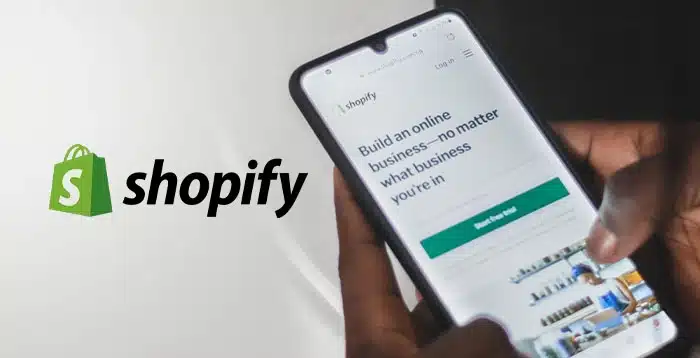 Shopify website being used by a person on a mobile phone.