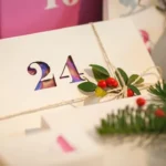 A gift decorated with flowers on a table.