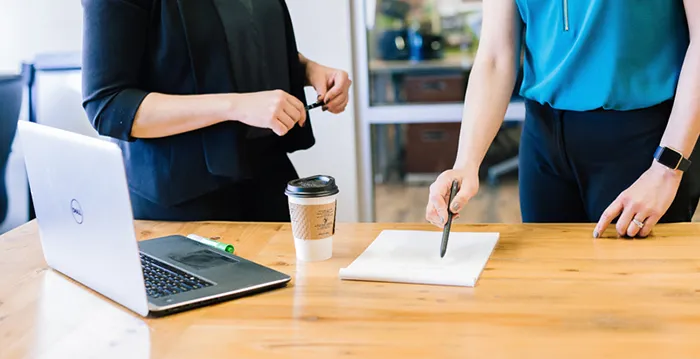 A few people working at a table.