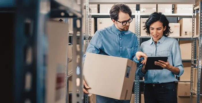 A man and a woman looking at a laptop.