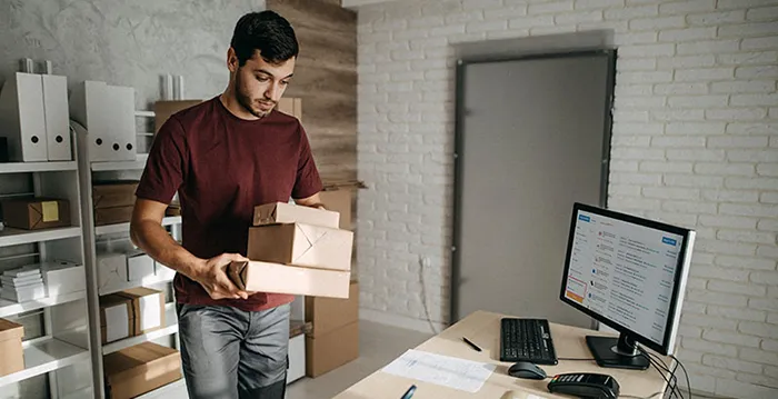 A man holding a boxes.