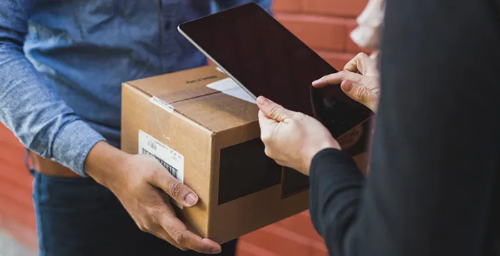 A group of people holding boxes.
