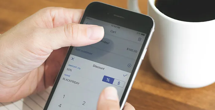 Close up of a mobile phone presenting discount.