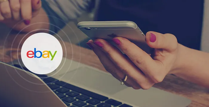 A woman's hand holding a tablet.