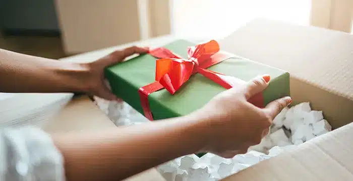 A person holding a gift box.