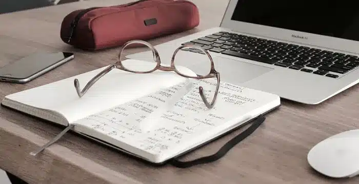 A pair of glasses on a notebook.