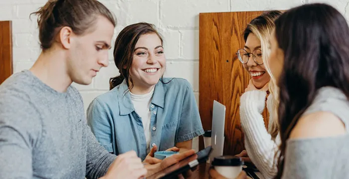 A group of people talking and smiling.