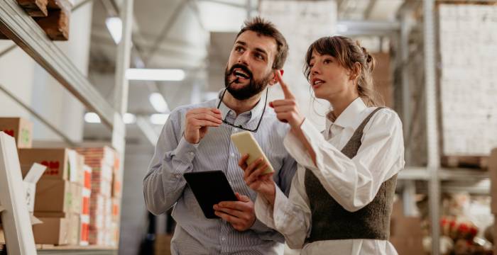 Two workers in a warehouse using the LIFO method for inventory valuation.
