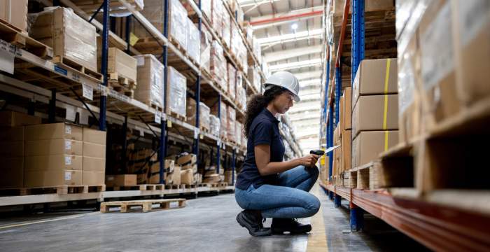 Woman scanning items in warehouse