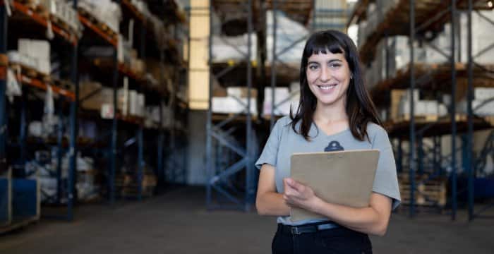 Woman checking stock against AI inventory management record