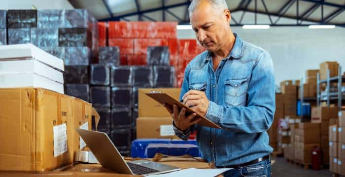 Warehouse worker calculating inventory costs