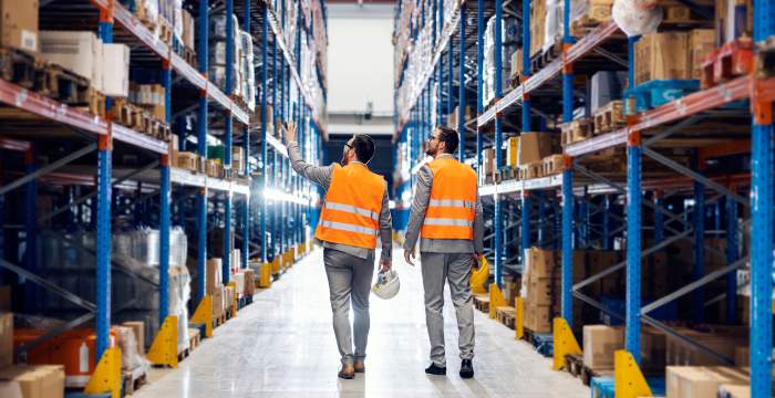 Businessmen visiting supplier warehouse