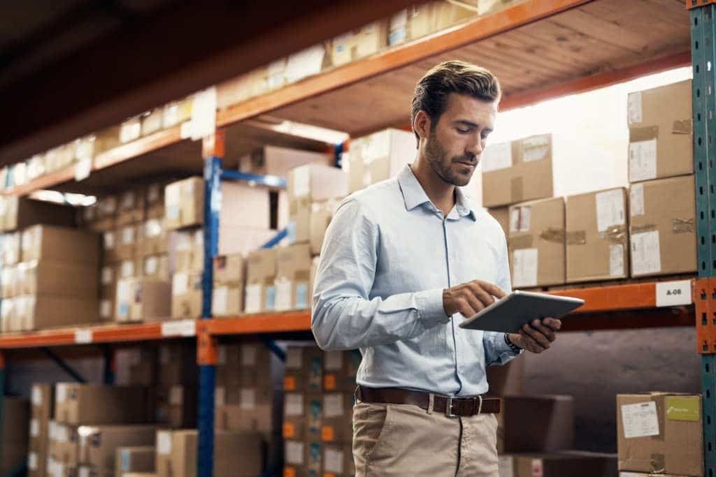 Businessman checking inventory in warehouse