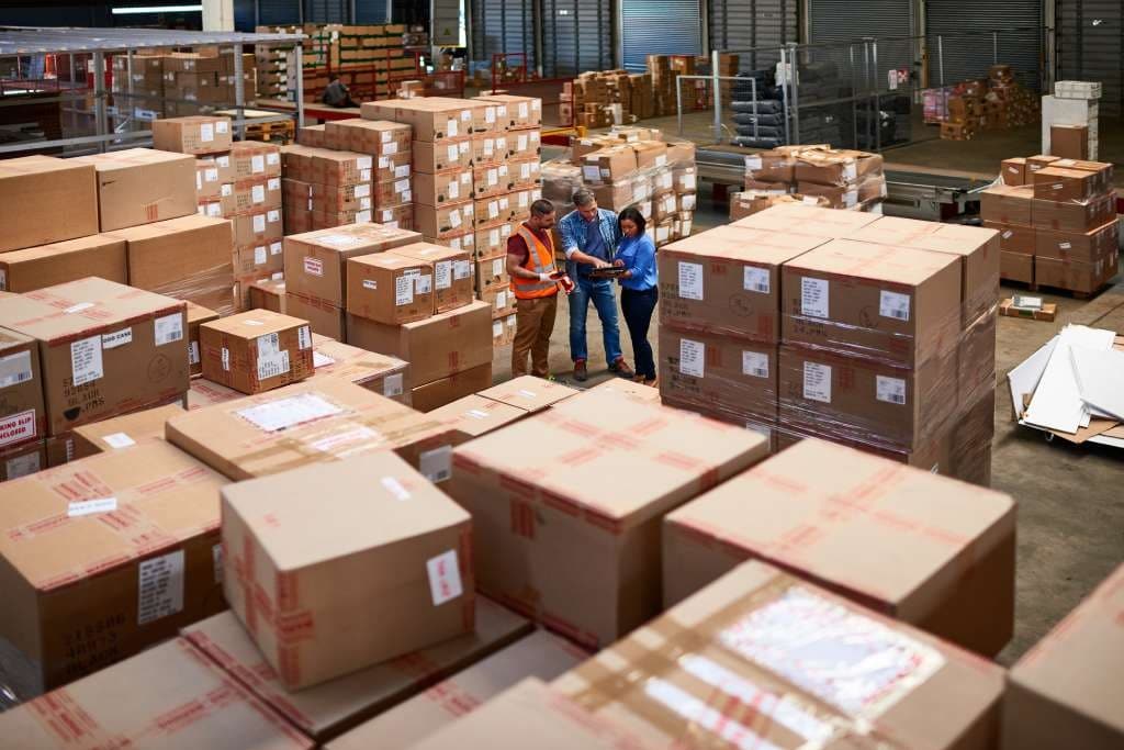 Colleagues using software to check warehouse stock