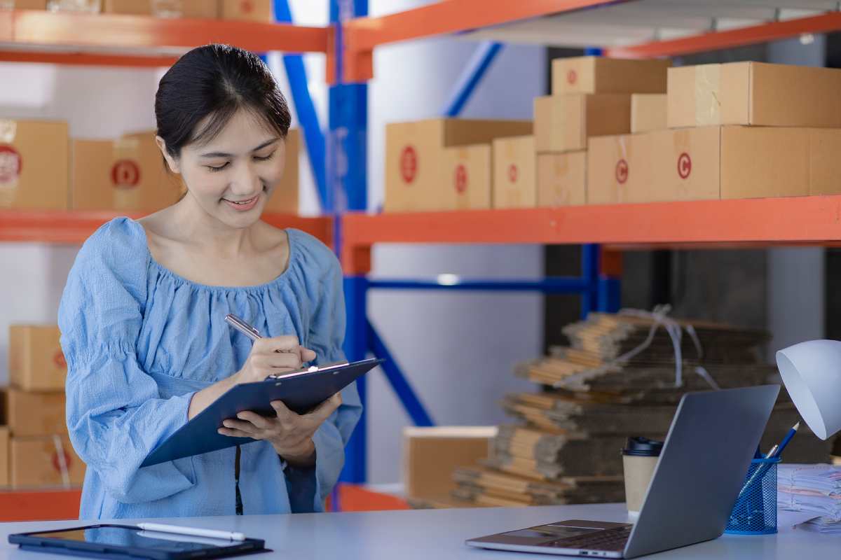 Business owner checking and sourcing inventory on laptop