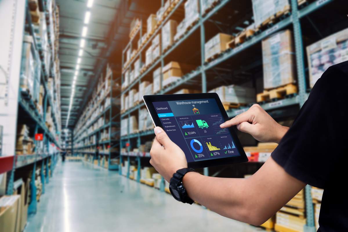 Warehouse automation worker using iPad to check stock