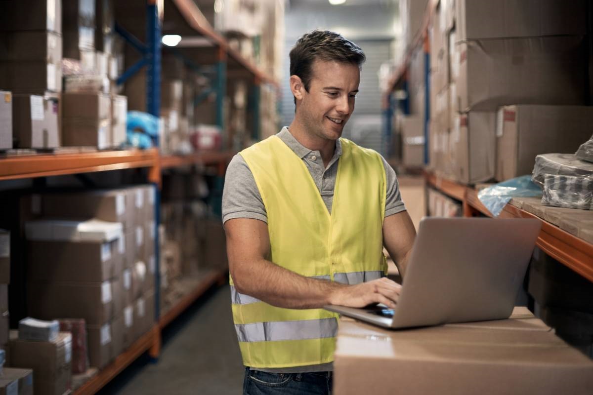 Amazon seller using inventory management software on laptop